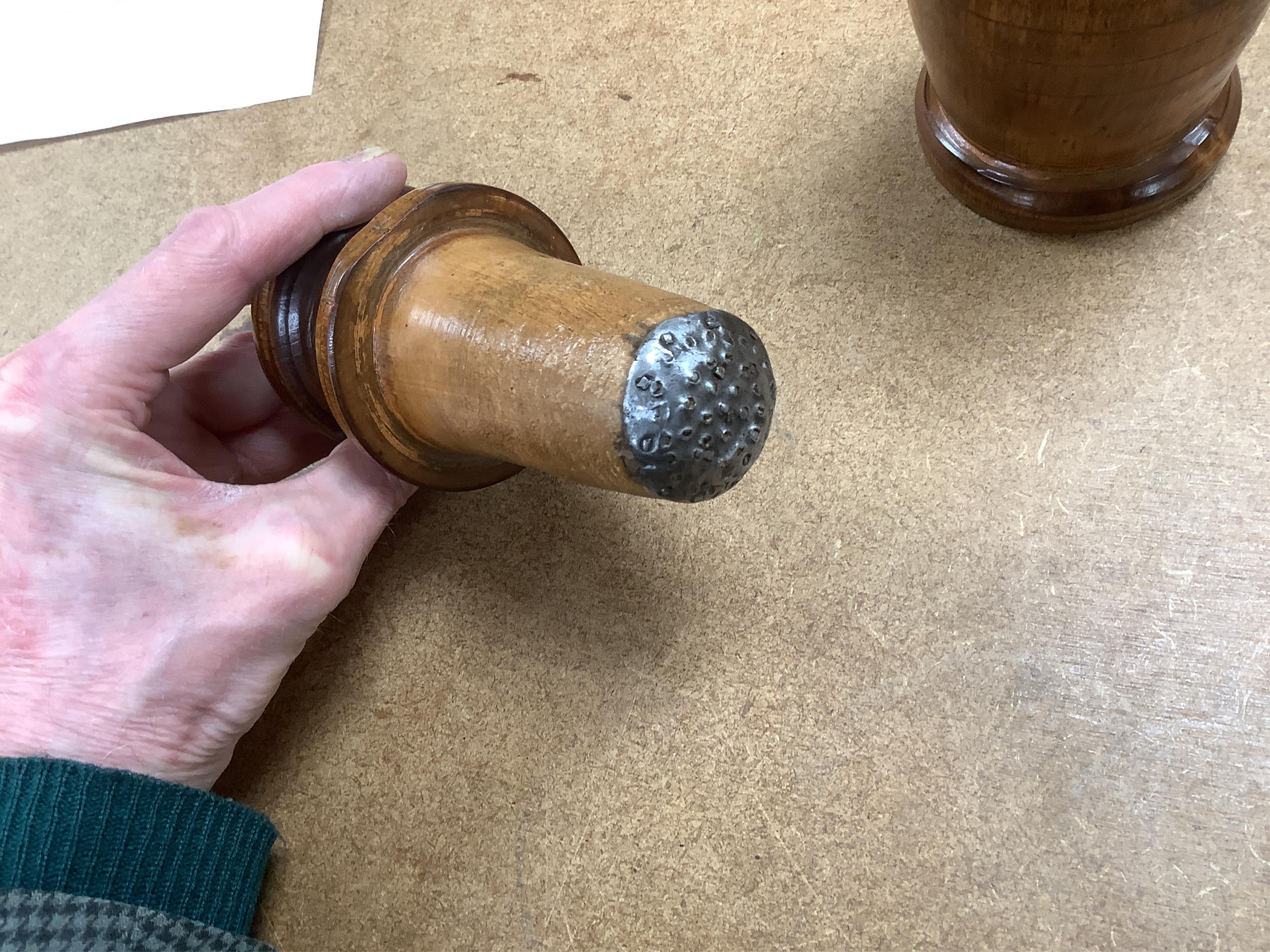 Sundry items to include a large pestle, spice grinder, flat iron on stand, bronze mortar and three other items, largest 42cm in length
